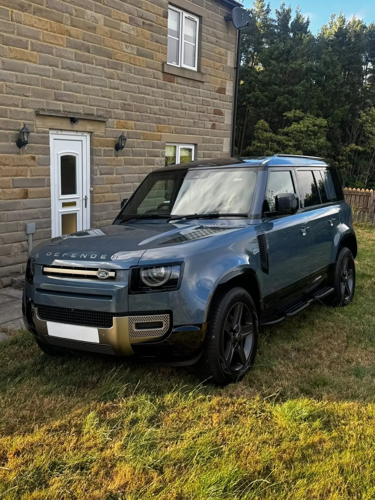 Blue-grey Land Rover Defender with a deep gloss finish